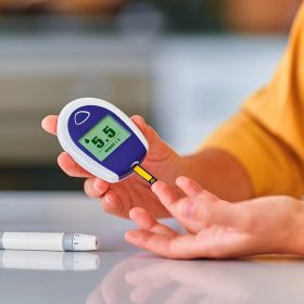 diabetic-patient-checks-blood-glucose-level-home