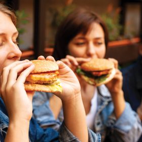 group-three-friends-enjoying-burgers