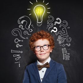 little-boy-with-ginger-hair-lightbulb-chalkboard-background