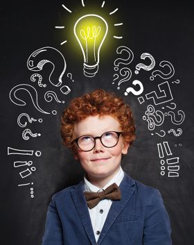 little-boy-with-ginger-hair-lightbulb-chalkboard-background