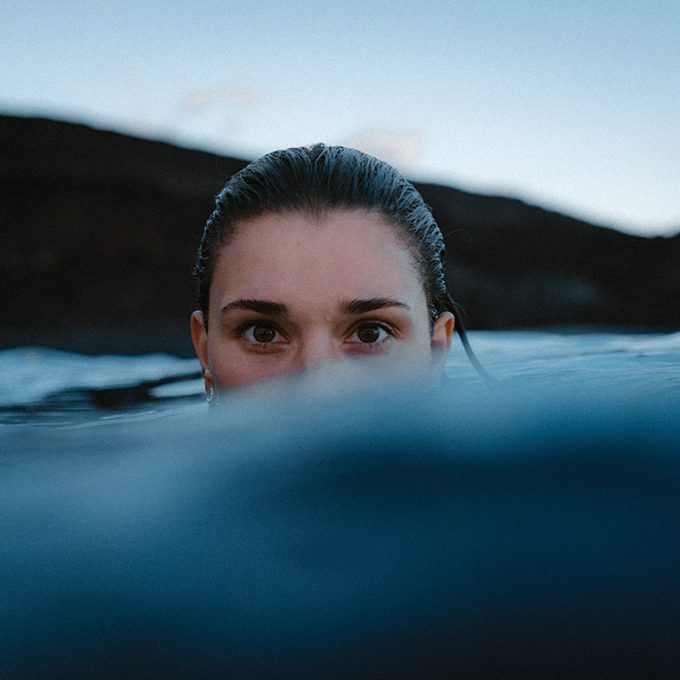 portrait-woman-swimming-sea-against-sky
